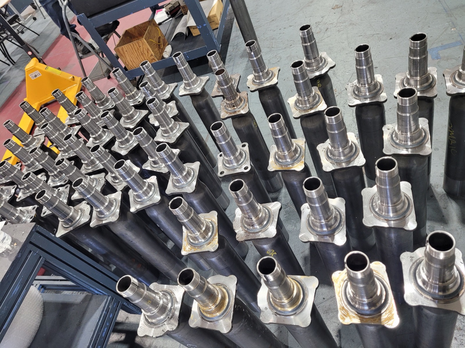Batch of axle tubes prepared for keyway and thread processing.
