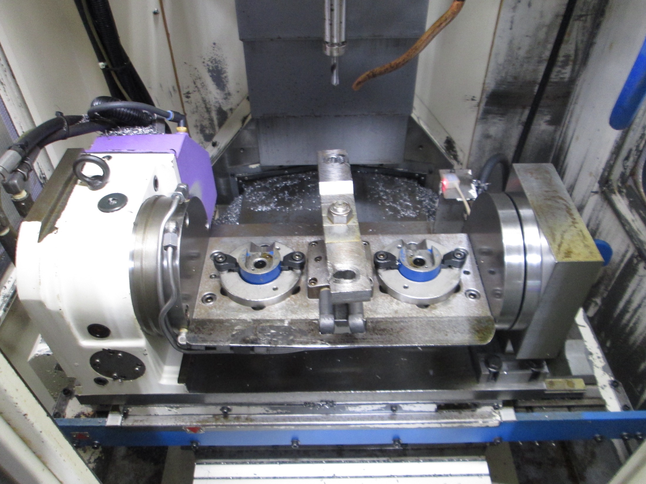 Earlier in-machine setup from project archive showing baseline rotary workholding state.